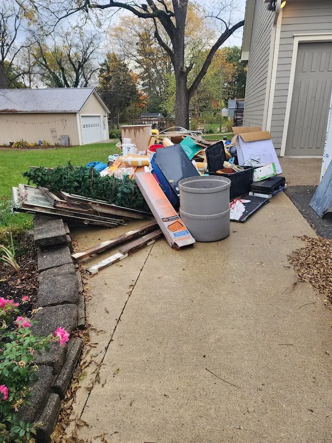 Dumpster being loaded with debris for Roofing Dumpster Rental in Pilot Point